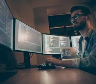 Side View Of A Guy Working At A Data Terminal